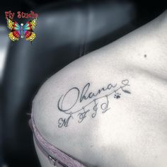 the back of a woman's shoulder with an inscription on it that says, ohana