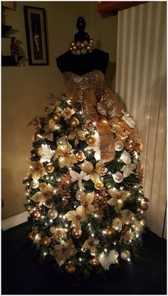 a christmas tree with gold and white decorations