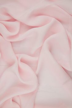 Baby Pink Silk Double Georgette Fabric is a remarkably durable, lightweight premium silk that offers an extremely graceful drape and a soft, dull finish. This fabric is ideal for blouses, gowns, dresses, and overlays. The fabric's soft, airy appearance also makes it suitable for scarves and other accessories. The fabric is sold by the Yard, and measures 44 inches in width. Baby Pink Silk, Draping Fabric, Spring Event, Dupioni Silk, Georgette Fabric, Silk Wool, Pink Silk, Pink Fabric, Wool Fabric