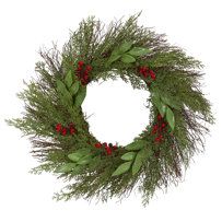 a christmas wreath with red berries and greenery