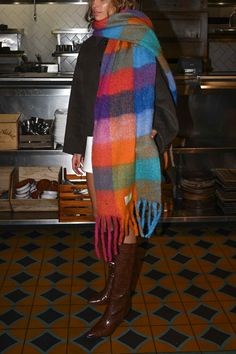 Made from recycled fabric and designed for layering in cold weather the Leah Scarf is our oversized, ultra soft blanket scarf with a colored plaid pattern and loose fringe ends. Wrap the Leah Scarf around once or twice for a luxe, blanketed look. Oversized, mid-weight scarf Multicolored plaid pattern Mixed watercolor hues of orange, green, red, and blue Loose twisted fringe ends 97% recycled polyester, 3% recycled wool 11.6 inches x 90.5 inches Accessories are final sale for sanitary purposes. Y Chunky Plaid Scarf, Long Scarf Aesthetic, Colorful Winter Scarf, Funky Scarf Outfit, Huge Scarf Outfit, Giant Scarf Outfit, Big Scarf Outfit Chunky Scarves, Knit Scarf Aesthetic, Winter Outfits With Scarves