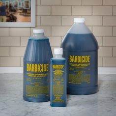 two bottles of barbicide sit on a counter