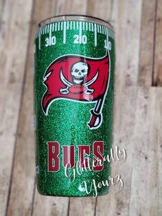 a green glitter tumbler with the tampa football team on it