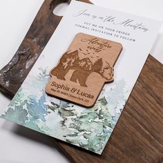 a wooden save the date magnet on top of a cutting board