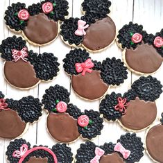 decorated cookies are arranged in the shape of mickey and minnie mouses heads with bows