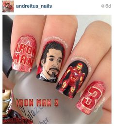 the iron man nail art is on someone's nails and it looks like they have been