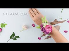 two hands holding flowers on top of a white surface with the words and you're done