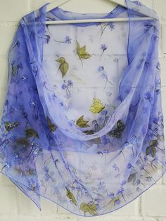 Hand painted charming silk chiffon scarf - Hepatica flowers. Alluring Blue-violet small Spring flowers blossoming all length long of this scarf. Few spring butterflies accompany this nature beauty. In Lithuanian language we call this flower 'Zibuokle'- that who sparkle , twinkle :) Truly these flowers seem shine in early spring on last autumn leaves ground . And So this painting was inspired :) Chiffon is very light and transparent silk fabric. It is transparent in one layer and rich colors are Purple Silk Scarf With Floral Print For Spring, Purple Floral Print Silk Scarf For Spring, Spring Butterflies, Spring Shawl, Spring Wraps, Purple Spring, Silk Chiffon Scarves, Painted Silk, Hand Painted Silk