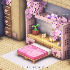 a pink bed sitting in front of a window next to a wooden shelf filled with flowers