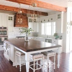 a large kitchen with an island in the middle