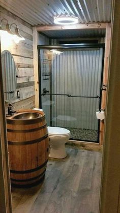 a bathroom with a wooden barrel in it