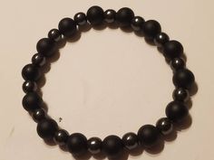 This classy Men's Chakra bracelet features Matte Black Onyx 8 MM beads with natural Hematite 6 MM beads. It's a perfect gift for him, or her, as a reminder of grounding and attracting positive and protective energies. A custom bracelet made only at Divinity Jewelers. Casual Black Hematite Jewelry, Black Hematite Round Beaded Bracelets, Black Hematite Beaded Bracelets, Healing Crystal Bracelets, Healing Gemstone Bracelets, Custom Bracelet, Crystal Healing Bracelets, Onyx Bracelet, Chakra Bracelet