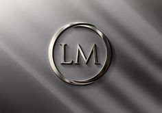 the lm logo is shown on a metallic surface with a circular ring around it