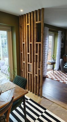 a dining room and living room with wood partitions