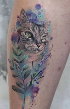 a cat with green eyes is shown on the thigh and it's watercolor paint splatches