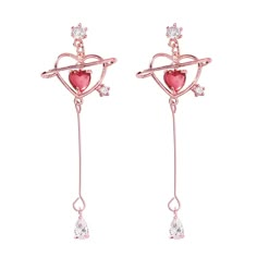 These delicately dangling drop earrings feature sparkling cubic zirconia embellishments and a dainty heart-cut crystal inside an 18-karat gold-plated open heart. 0.39" W x 1.85" L 18k gold-plated copper / red crystal / cubic zirconia Saturn Earrings, Anime Earrings, Pink Heart Earrings, Kawaii Earrings, Kawaii Jewelry, Heart Dangle Earrings, Heart Shaped Earrings, Heart Drop Earrings, Pretty Jewelry