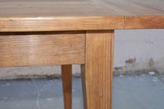 a close up of a wooden table with no one at it's base or legs