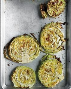 four pieces of cooked cabbage on a baking sheet