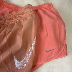 2 Pairs Of Nike Shorts Size Small. Coral Shorts Were Used Once And Washed The Mauve Color Shorts Are Brand New Without Tags Nike Summer Workout Shorts, Nike Athletic Shorts For Beach In Spring, Nike Orange Short Bottoms, Nike Orange Workout Bottoms, Nike Orange Shorts, Nike Orange Bottoms For Spring, Nike Orange Shorts For Spring, Pink Nike Pros, Coral Shorts