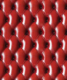 a red leather upholstered wall with buttons