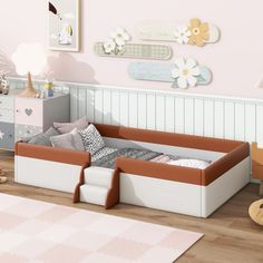 a child's bedroom with pink walls and white furniture, including a toddler bed