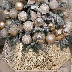 a christmas tree decorated with gold and silver ornaments