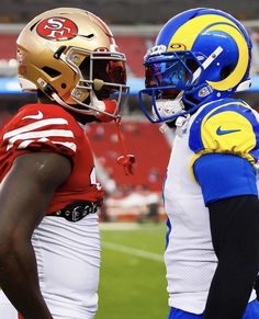 two football players standing next to each other on a field