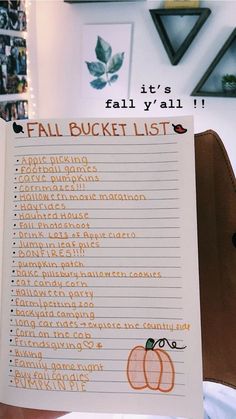 a hand holding up a fall bucket list