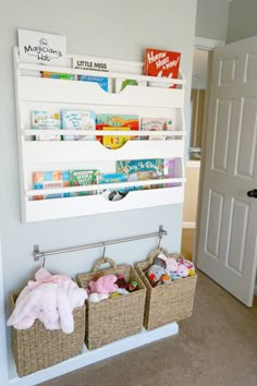 the bookshelf is filled with children's books and stuffed animals in baskets