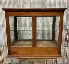 an old wooden display case with glass shelves