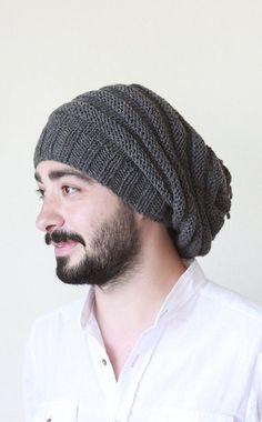 a man with a beard wearing a knitted hat