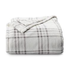 the white and brown plaid blanket is folded up