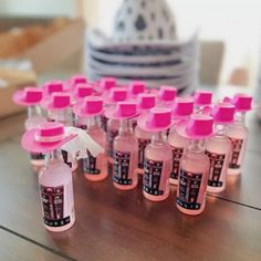 pink bottles are lined up on a table