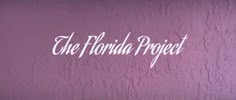 the florida project logo on a purple wall