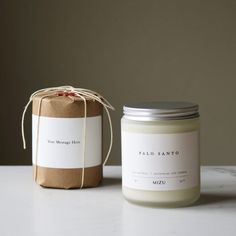 a jar of candle next to a brown paper bag