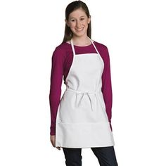 a woman wearing an apron and smiling at the camera with her hands in her pockets