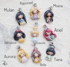 the little princesses are all wearing tiaras and holding their names in spanish on this keychain