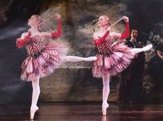 two ballerinas dressed in red and pink tutus