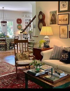 a living room filled with furniture and pictures on the wall