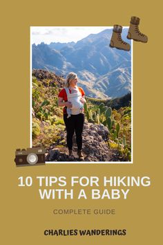 a woman standing on top of a mountain next to a baby in a white shirt