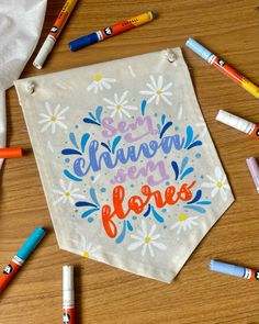 some crayons and markers are laying on a table with a white towel that says, i'm always happy floress