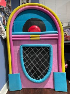 an inflatable play area with a red ball on the top and blue bottom