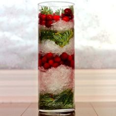 a glass filled with ice and red berries