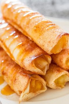 three crepes stacked on top of each other with honey syrup drizzled over them