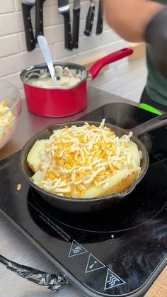 a pan filled with food sitting on top of a stove