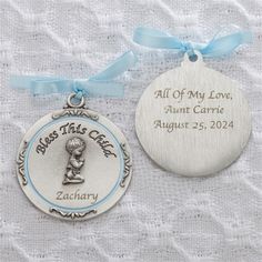 two personalized christmas ornament ornaments on a white cloth with blue ribbon and bow