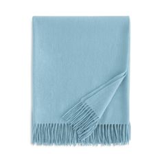 a light blue blanket with fringes on it