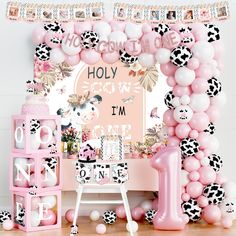 a pink and black themed birthday party with balloons