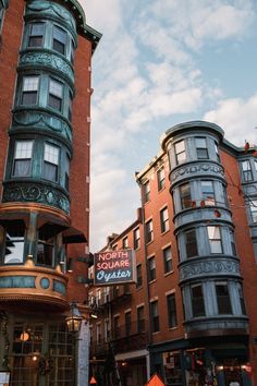 the corner of a city street with tall buildings