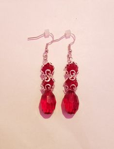 A pair of earrings made using red beads and silver bead caps. Each pair comes with 2 earring backs as shown in picture. Red Bead Earrings, Great Gifts For Mom, Red Bead, Bead Caps, Earring Backs, Silver Beads, Beaded Earrings, Gifts For Mom, Jewelry Earrings Dangle